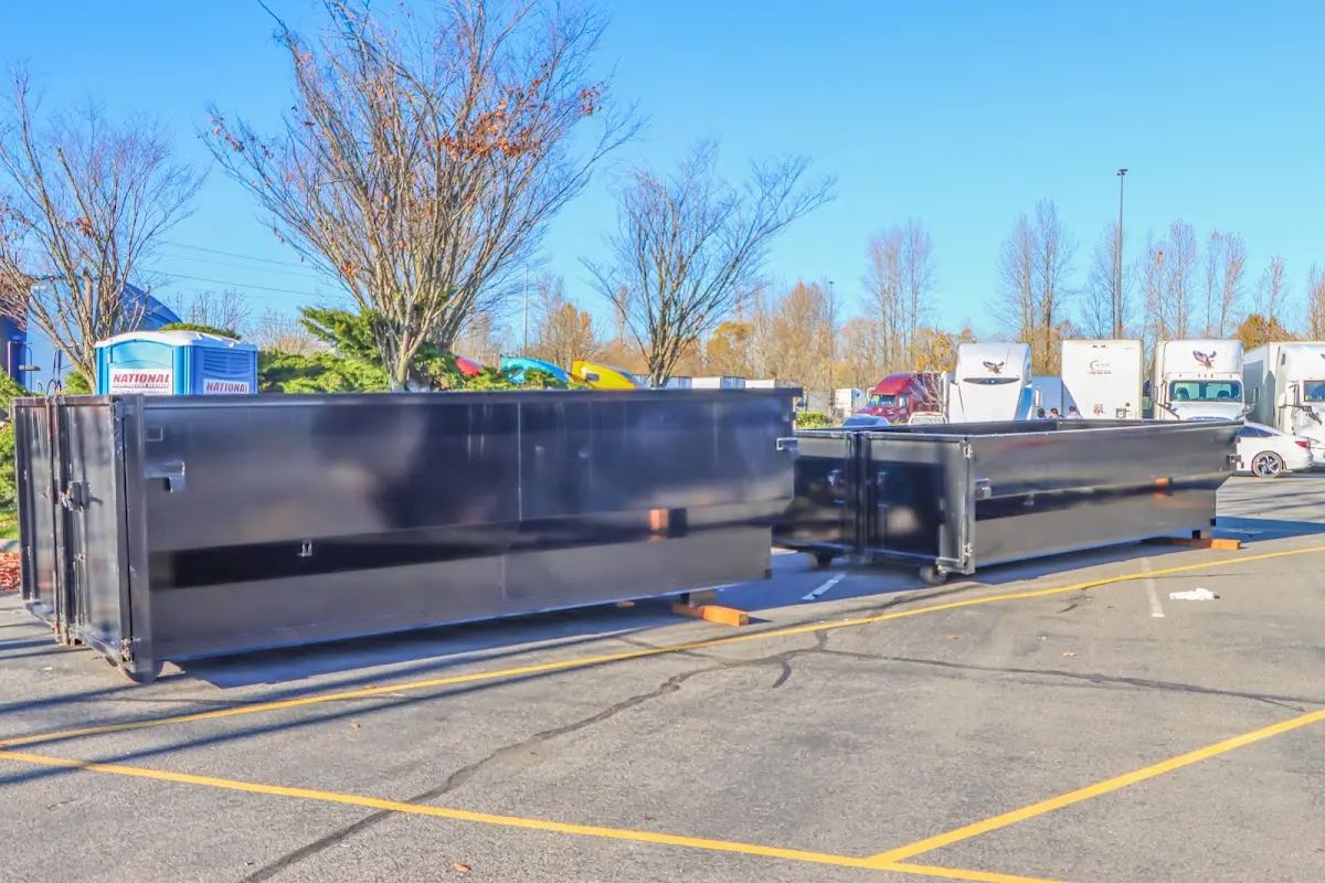 Professional dumpster rental service with roll-off container on residential driveway in Lake Oswego